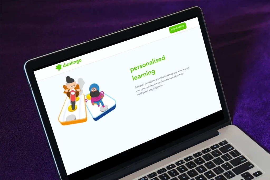 Laptop showing the Duolingo website with the title ‘personalised learning’ and two characters